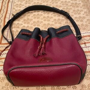 Dooney Bourke bag, pebbled leather, maroon/black. tasseled closure, abt. 10”X12”
